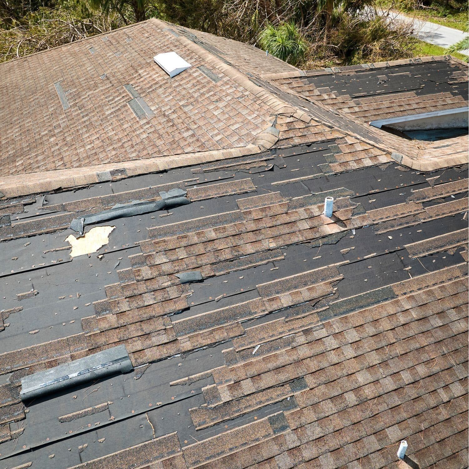 Roofing crew installing new shingles on weathered West Texas family home